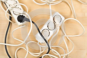 Cable chaos clutter from multiple electric wire extension cords photo