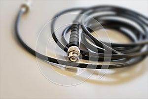 Cable coaxial black with silver connector for transmitting television signal for connecting cable television photo