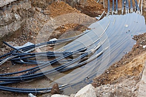 Cable cord laying in subsoil waters at construction site photo