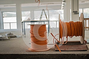 Cable drums with orange fiber cable on a construction site