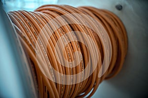 Cable drums with orange fiber cable on a construction site