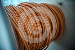 Cable drums with orange fiber cable on a construction site photo