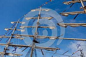 Cable ladders, mast and ropes of a sailing ship against the blue sky. Concept of travel, adventure and sea.