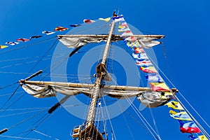 Cable ladders, mast and ropes of a sailing ship against the blue sky. Concept of travel, adventure and sea.