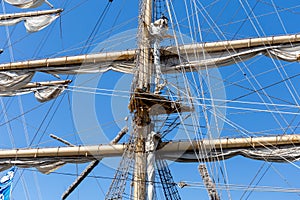 Cable ladders, mast and ropes of a sailing ship against the blue sky. Concept of travel, adventure and sea.