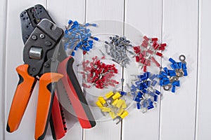 Cable lug in different colors and sizes, tools for crimping.