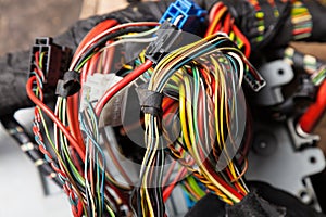 A cable of matted wires of different colors with connectors in the electrical wiring of the car. Internet line in the work of the photo