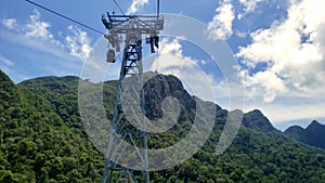 Cable park in the green mountains of a tropical island. High altitude cable car with breathtaking landscape view.