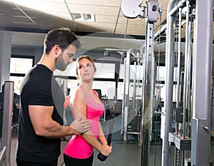 Cable pulley system personal trainer man and woman