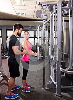 Cable pulley system personal trainer man and woman