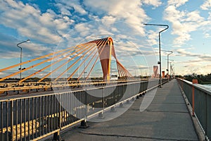 Cable-stayed bridge in Riga, in the photo south bridge in the evening against the background of blue sky and clouds photo