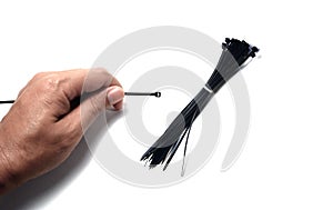 The cable tie in hand and bundle of black cable tie