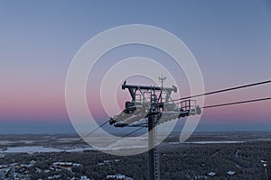 Cable way in Finland Levi on early morning sky background