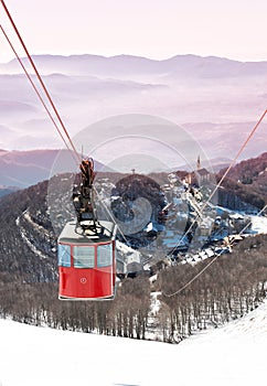 Cable-way on snowy italian mountains at dusk