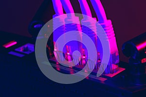 Cables plugged in a Wi-Fi router on dark background