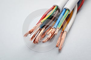 Cables with stripped wires on light background, closeup