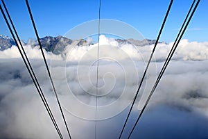 Cables from a Swiss cablecar disappear into clouds