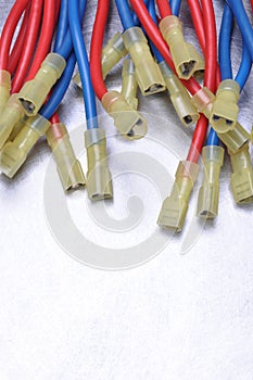 Cables with terminals used in electrical installation systems on grey metal background