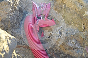 Cables in the trench. High-voltage cables in a protective covering in an excavation. Concept of electrical installations