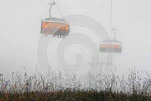 Cableway in foggy mountain