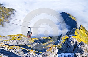 Cableway in the mountains. Transportation. The cable car descends into the mountain valley.