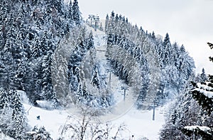 Cableway ski lift on ski slopes in winter scenery in Julian Alps, Kranjska Gora, Slovenia