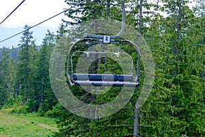 Cableway to Solisko station in the High Tatras, Slovakia. Lush green fir trees in the background