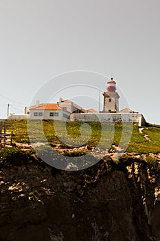 Cabo da roca lighthouse over the sea on a cliff  on a cloudy gloomy day