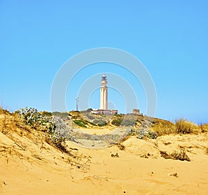 The Cabo de Trafalgar Cape Natural Park with the famous Lighthouse in the background. Barbate, Spain photo