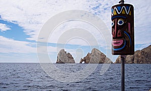 Cabo San Lucas Mexico native mask and island with hole in rock formation