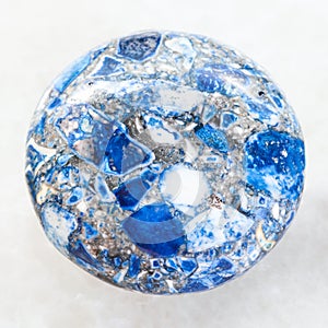 cabochon from pressed Lazurite stone on white