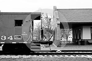 Caboose at the depot in black and white