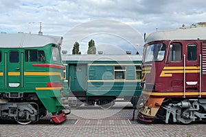 Cabs of modern Russian electric trains. Side view of the heads of railway trains with a lot of wheels and windows in the form of