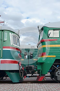 Cabs of modern Russian electric trains. Side view of the heads of railway trains with a lot of wheels and windows in the form of
