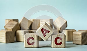 CAC - acronym on wooden cubes on a light background