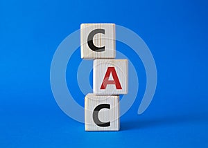 CAC - Customer Acquisition Cost symbol. Wooden cubes with word CAC. Beautiful blue background. Business and Customer Acquisition