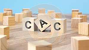 CAC written on wooden cube, business concept