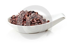 Cacao nibs in porcelain spoon