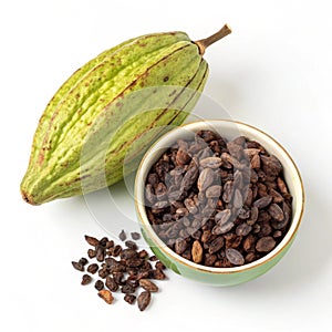 A cacao pod and a bowl of fair trade cacao nibs isolated on white background photo