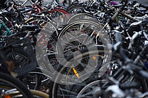 A cacaphony of bicyle tires in a pubic bike storage facility in Europe, Switzerland