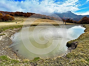 Cacciatore lake at prati di Sara autumn foliage, Italian Appennino