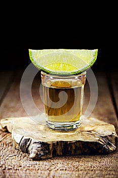 cachaÃ§a, brazilian drink with sugar, lemon and ice, typical distilled drink from brazil, on wooden bar background