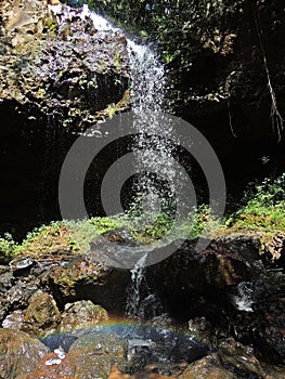 waterfall with a rainbow in front of it photo
