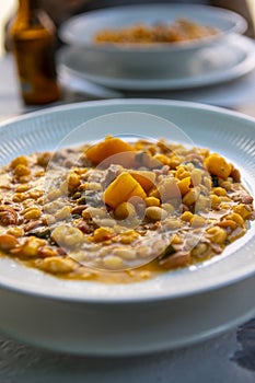 Cachupa Cape Verde traditional food with vegetables and beans macro in a bowl