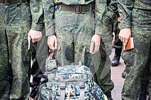 Cadets in military uniforms stand in a formation on the street photo