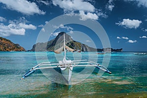 Cadlao panorama with Traditional filippino banca boat in front. Exotic tropical El Nido bay, Palawan Island, Philippines