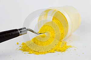 Cadmium Yellow pigment on a white background