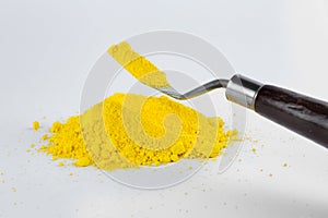 Cadmium Yellow pigment on a white background