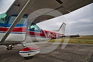 Small plane on aiport field. CESNA Blue white Red