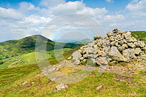Caer Caradoc and The Lawley Hills in the Shropshire Hills AONB in Shropshire, UK with a collection of Cairns in the foreground photo